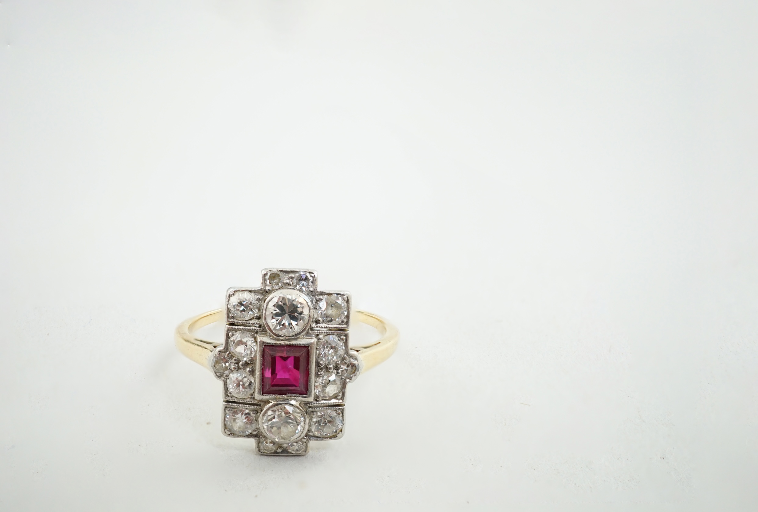 A 1920's gold and millegrain set ruby and diamond cluster dress ring